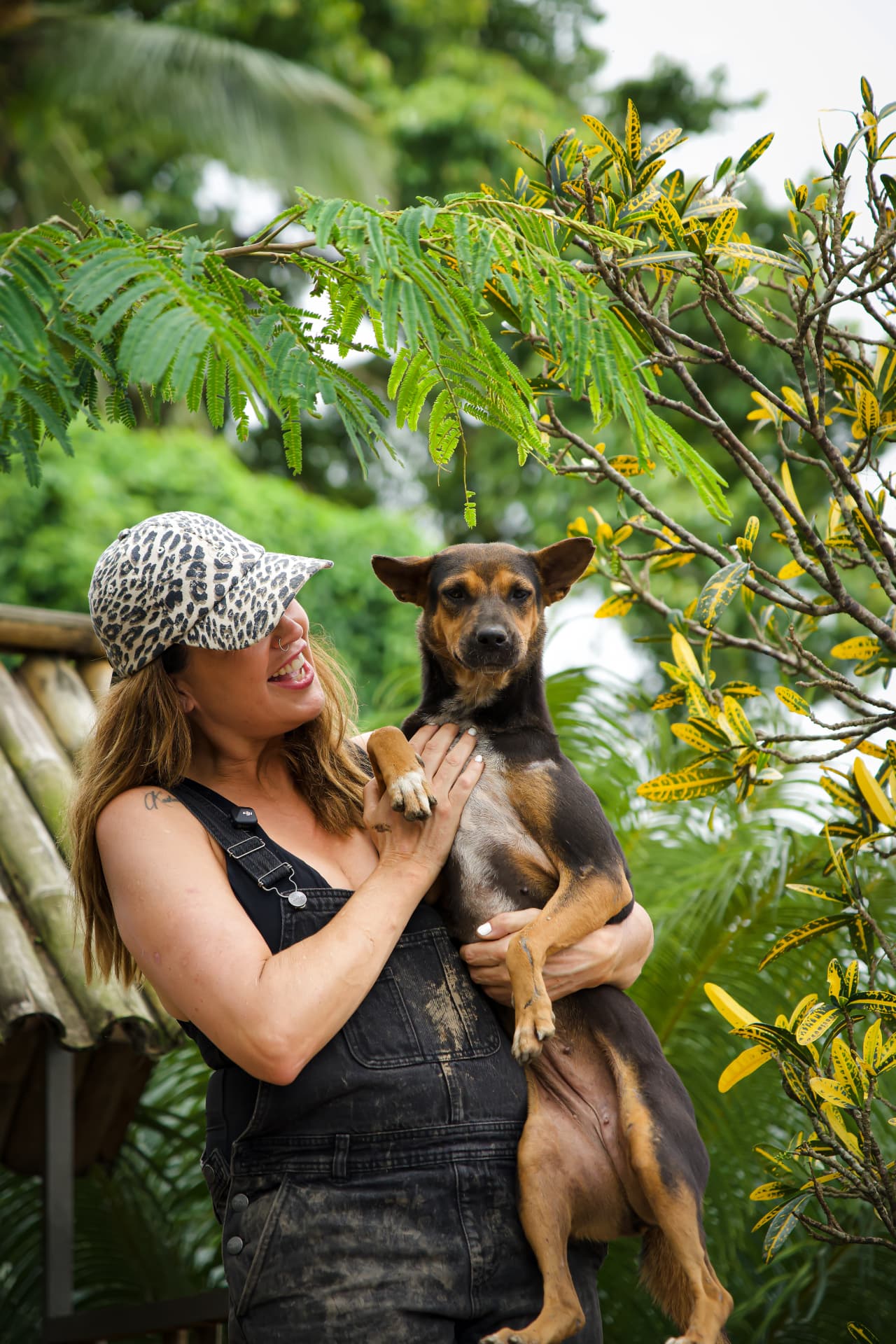 A caretaker cuddling a rescued dog at GAIA